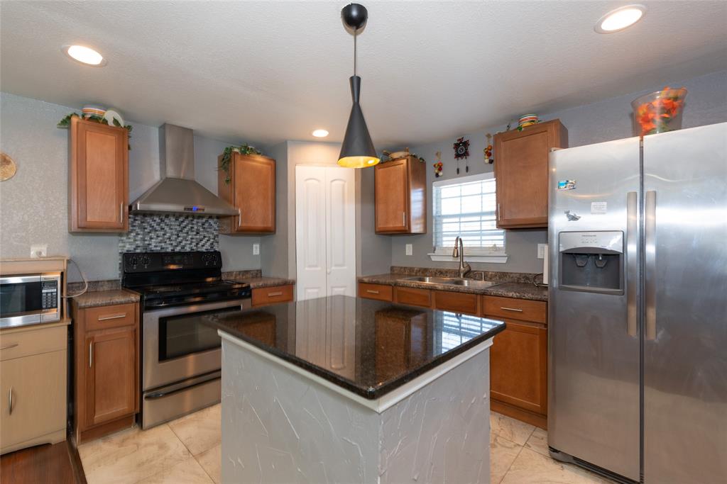 4405 Ray White Road, Unit A Fort Worth, TX 76244 - Photo 7 of 20 a kitchen with stainless steel appliances granite countertop a sink a stove and a refrigerator