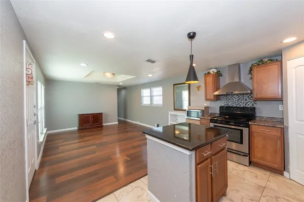 a kitchen with granite countertop a stove and a sink