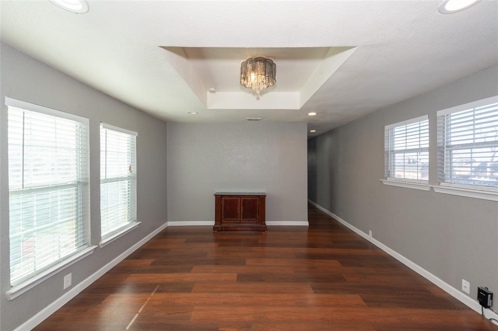 4405 Ray White Road, Unit A Fort Worth, TX 76244 - Photo 9 of 20 a view of an empty room with wooden floor and a window