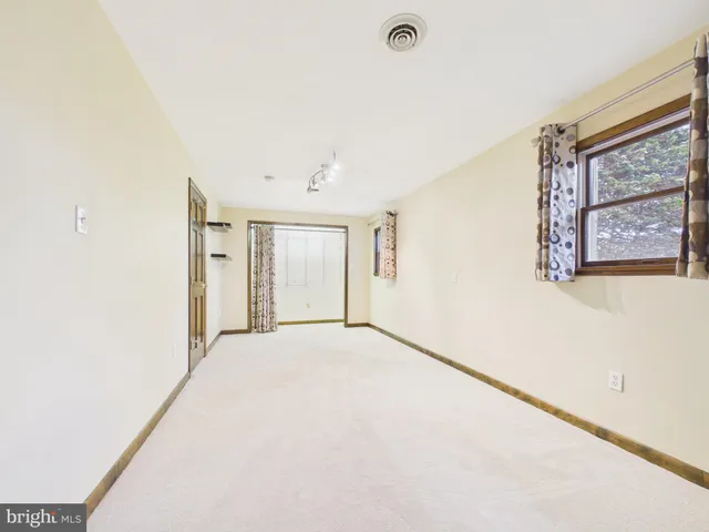 a view of a deck with two chairs and wooden fence