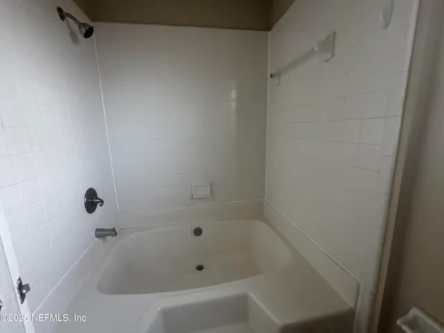 a view of empty room with windows and fireplace