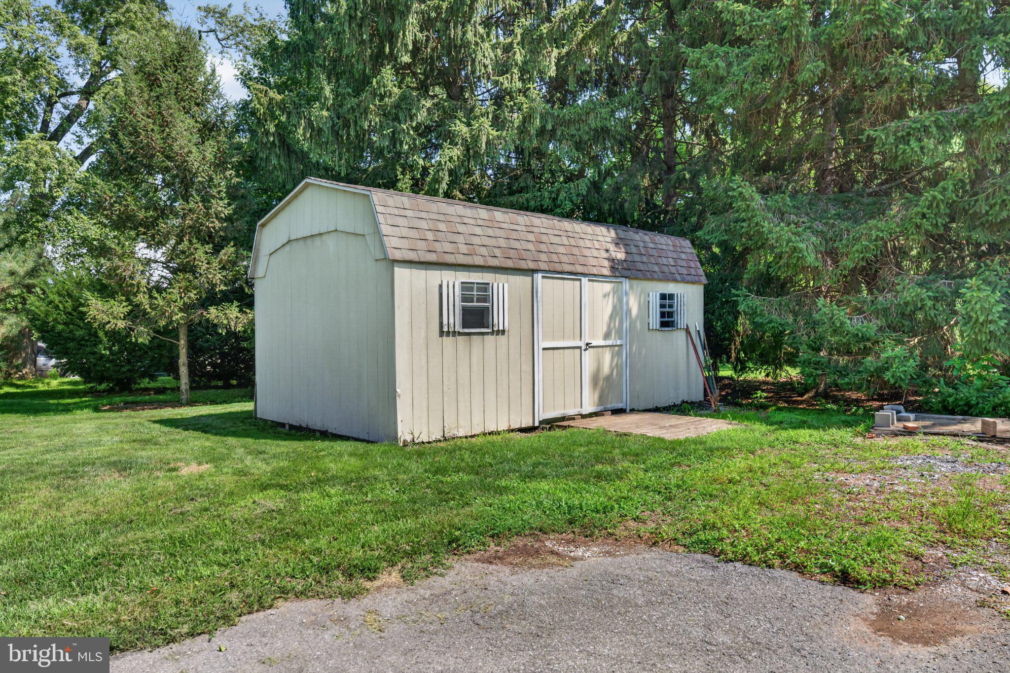 1277 South Colebrook Road Manheim, PA 17545 - Photo 50 of 65 Charming garden shed in lush greenery.