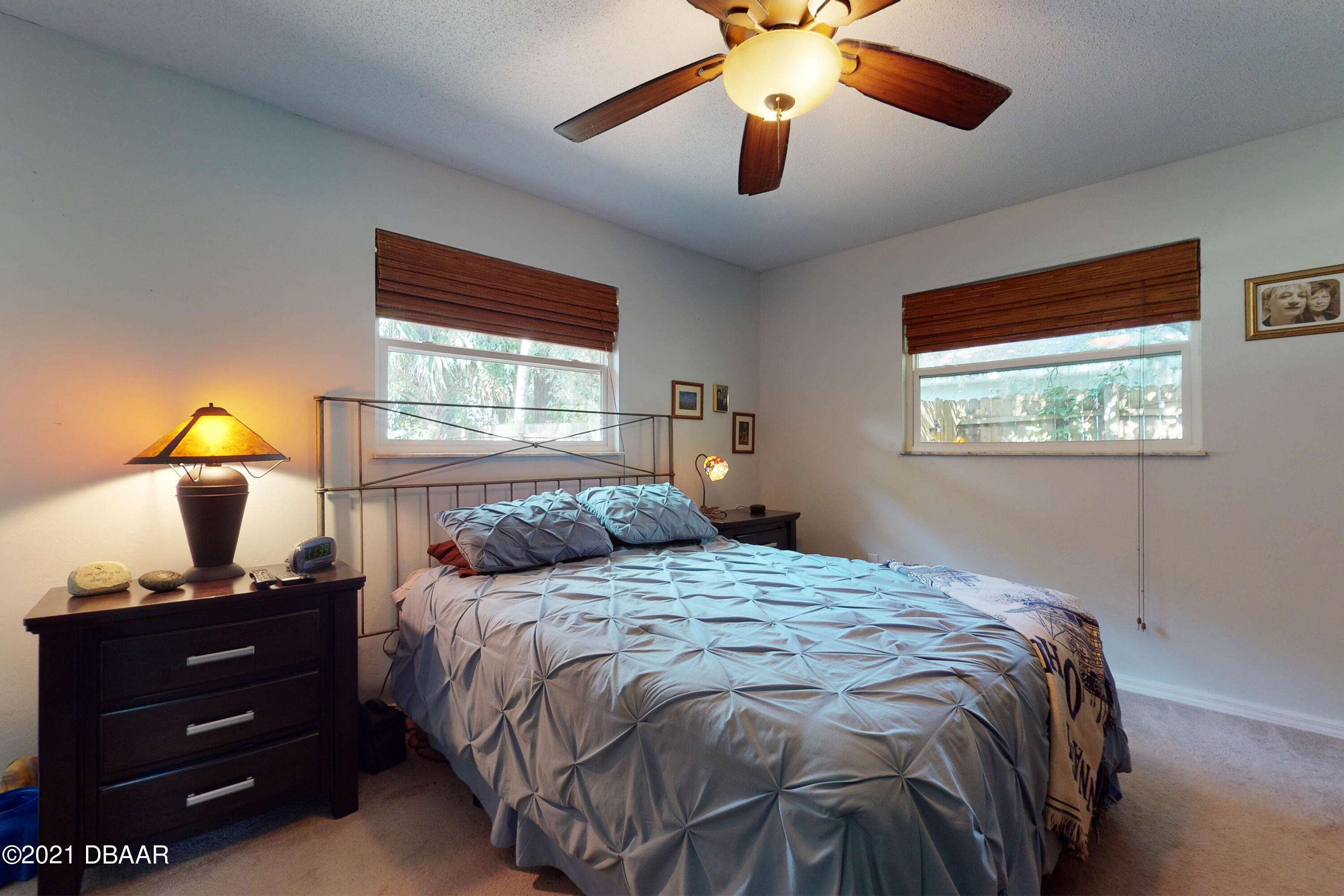 1522 Pine Tree Drive Edgewater, FL 32132 - Photo 12 of 26 a bedroom with a bed and a window