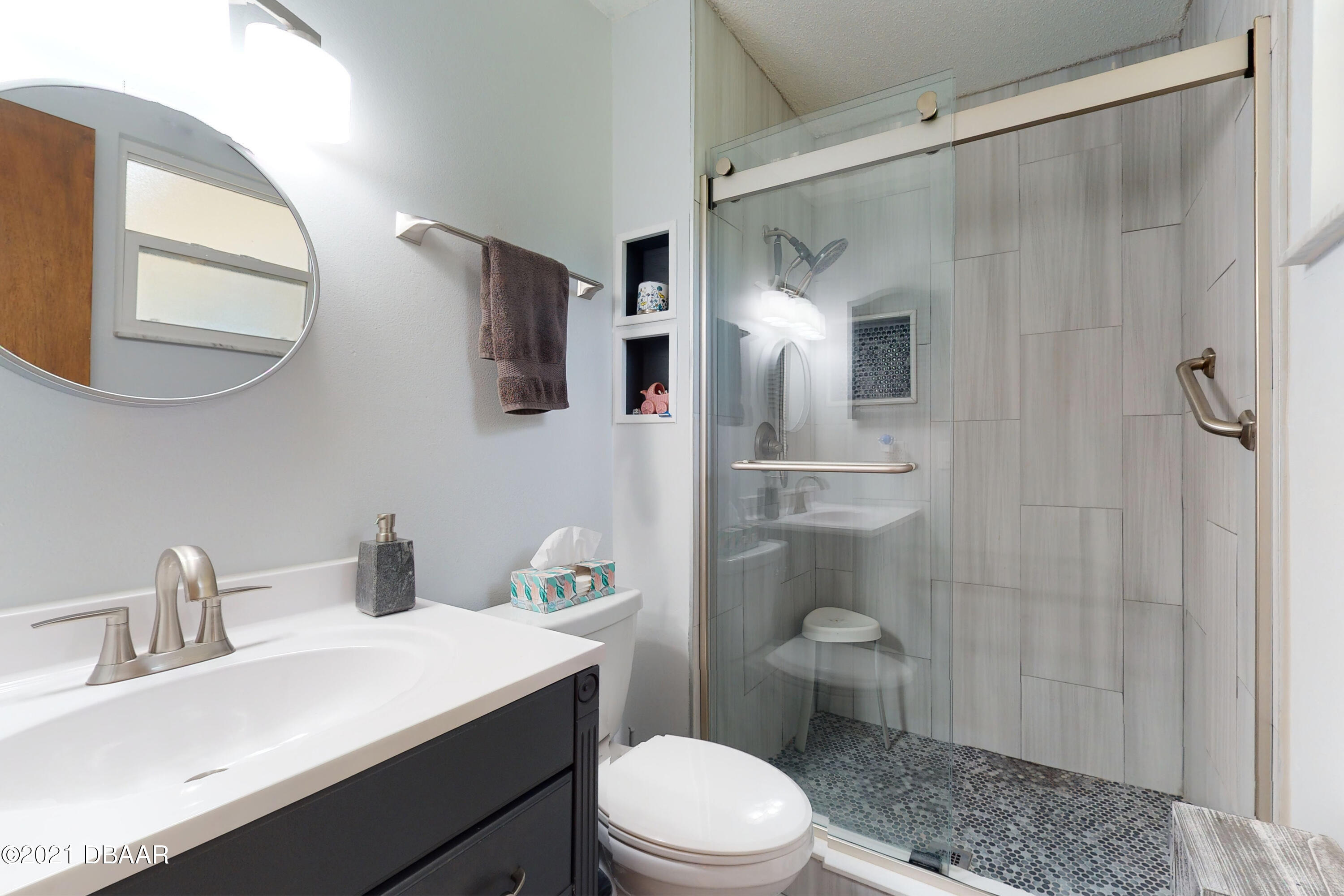 1522 Pine Tree Drive Edgewater, FL 32132 - Photo 13 of 26 a bathroom with a sink a toilet and shower