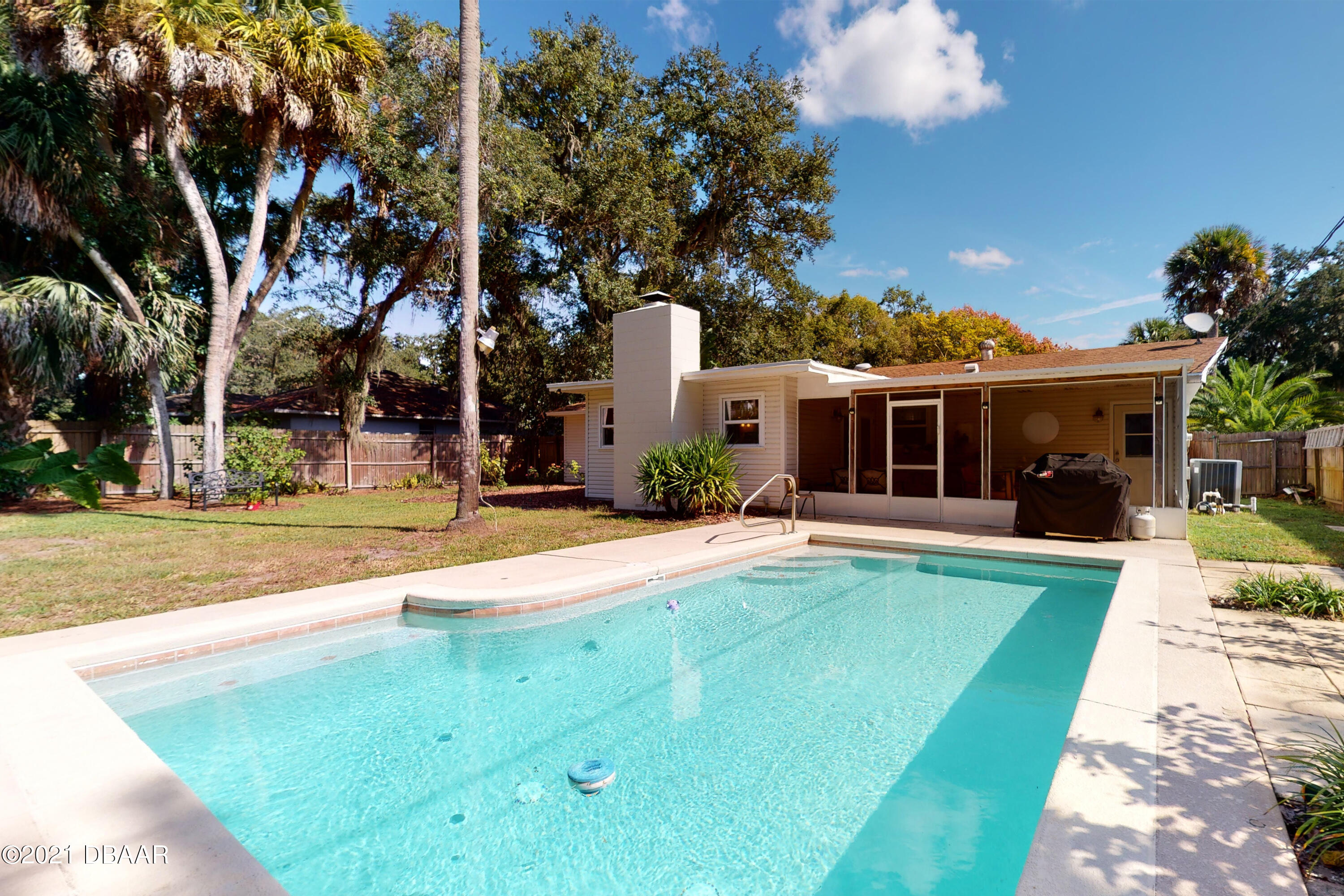 1522 Pine Tree Drive Edgewater, FL 32132 - Photo 16 of 26 a view of a house with swimming pool and a yard
