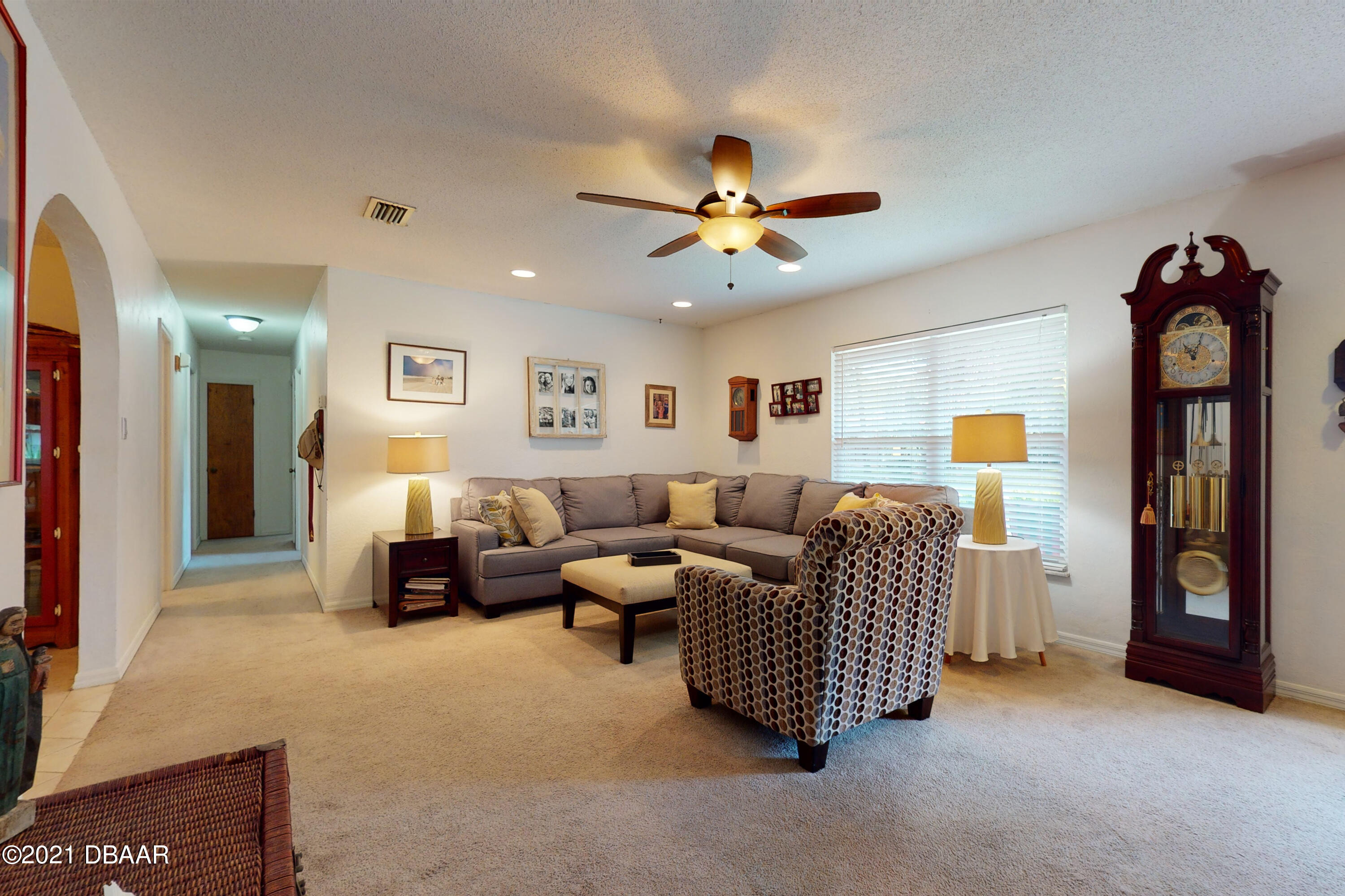 1522 Pine Tree Drive Edgewater, FL 32132 - Photo 2 of 26 a living room with furniture and a ceiling fan