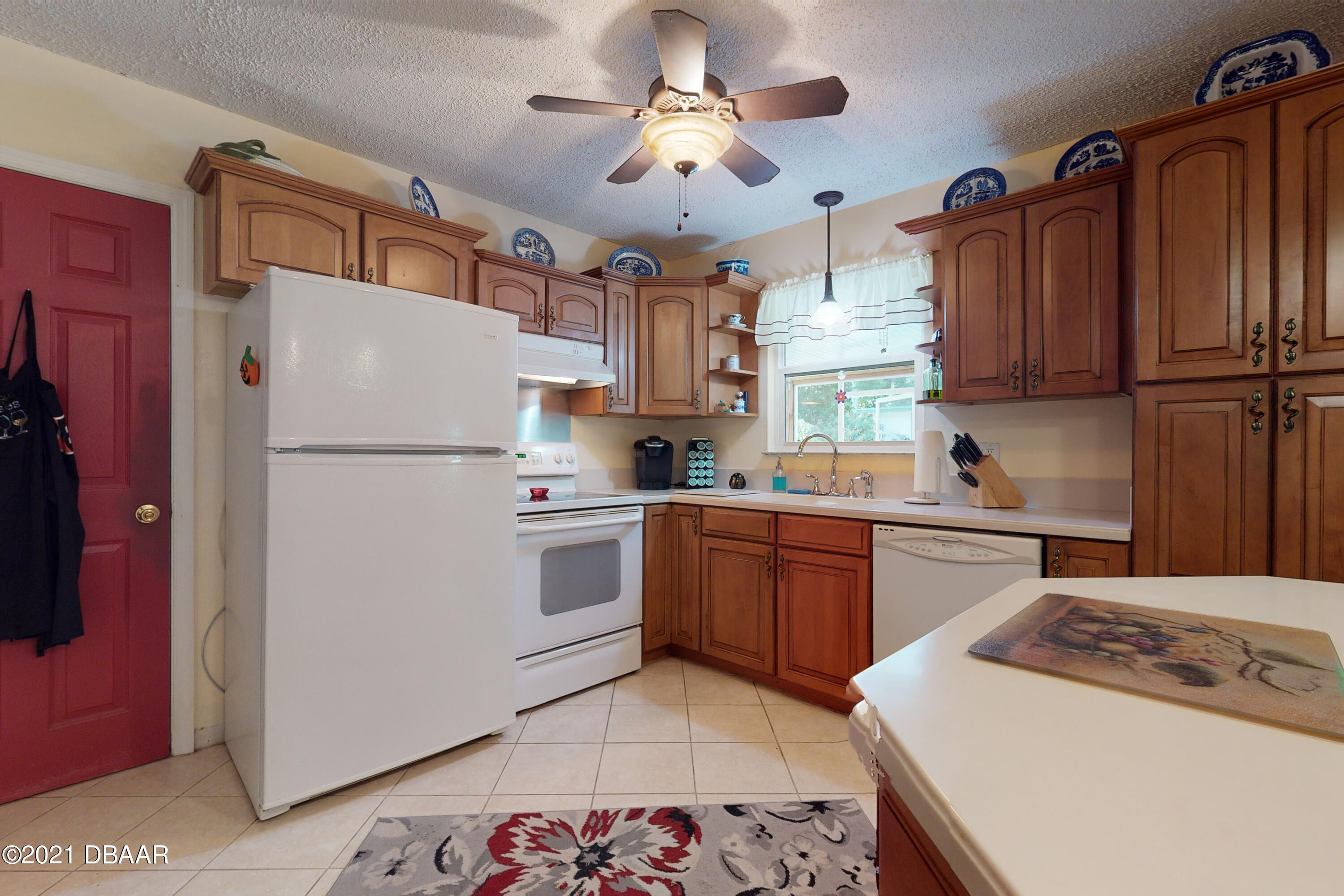 1522 Pine Tree Drive Edgewater, FL 32132 - Photo 5 of 26 a kitchen with stainless steel appliances granite countertop a refrigerator stove sink and cabinets
