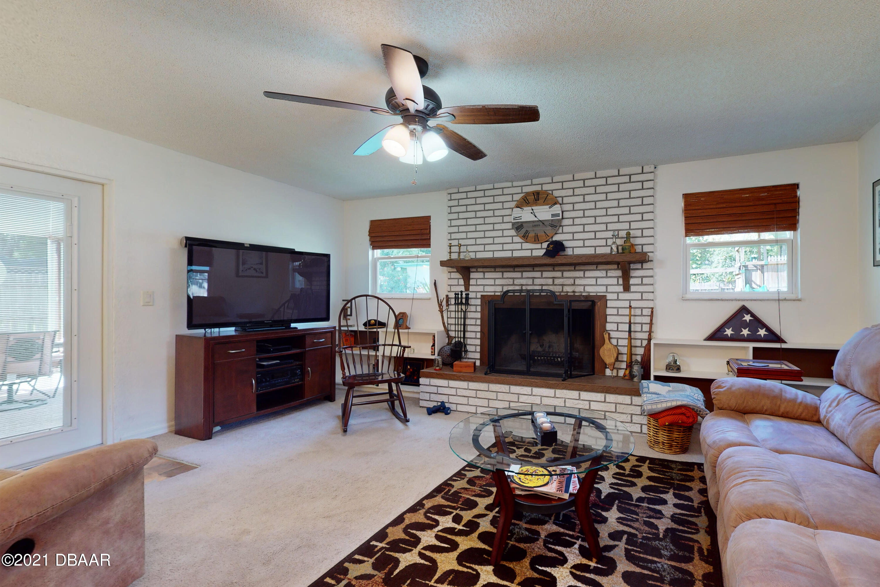 1522 Pine Tree Drive Edgewater, FL 32132 - Photo 8 of 26 a living room with furniture a window and a fireplace