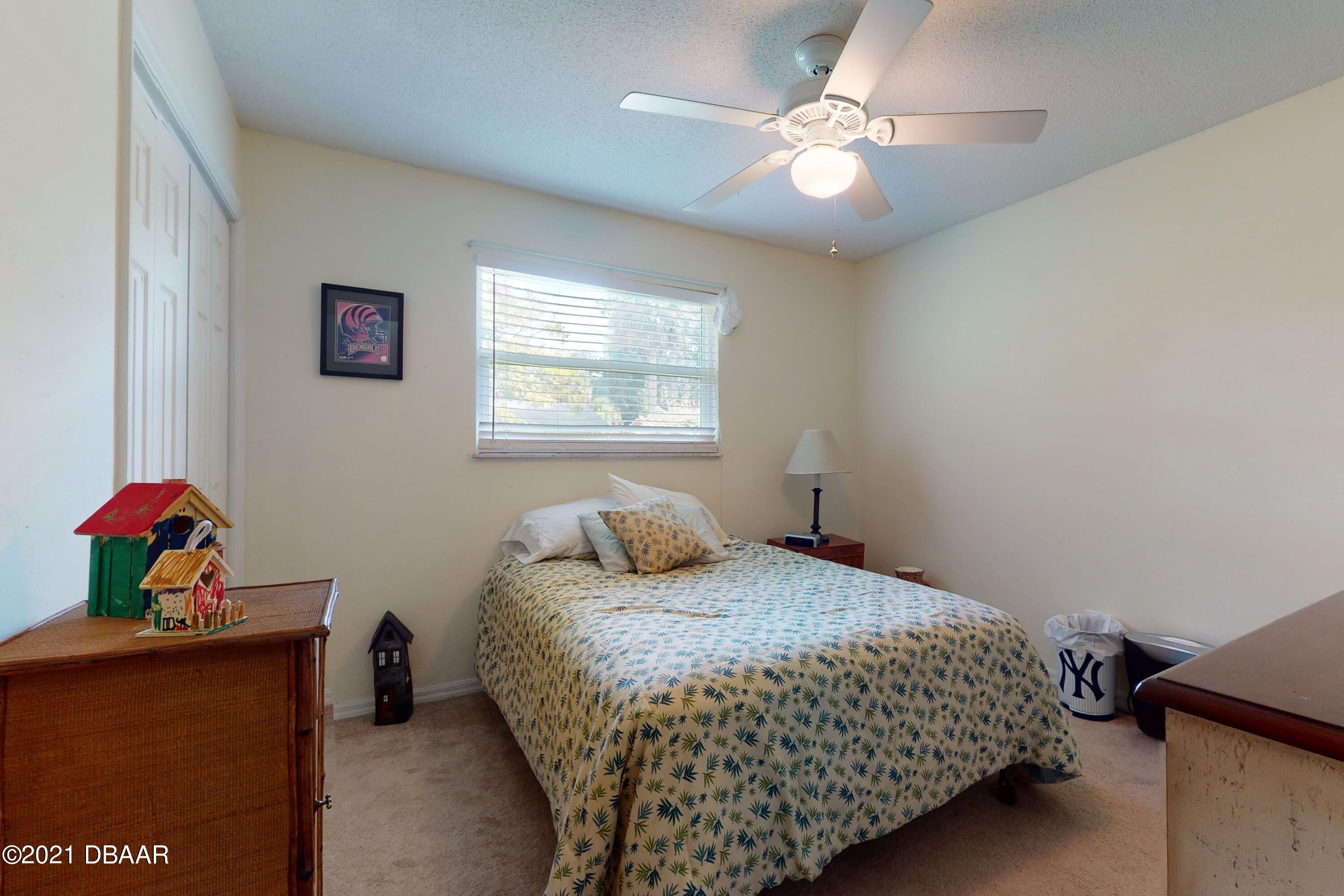 1522 Pine Tree Drive Edgewater, FL 32132 - Photo 9 of 26 a bedroom with a bed and a chandelier