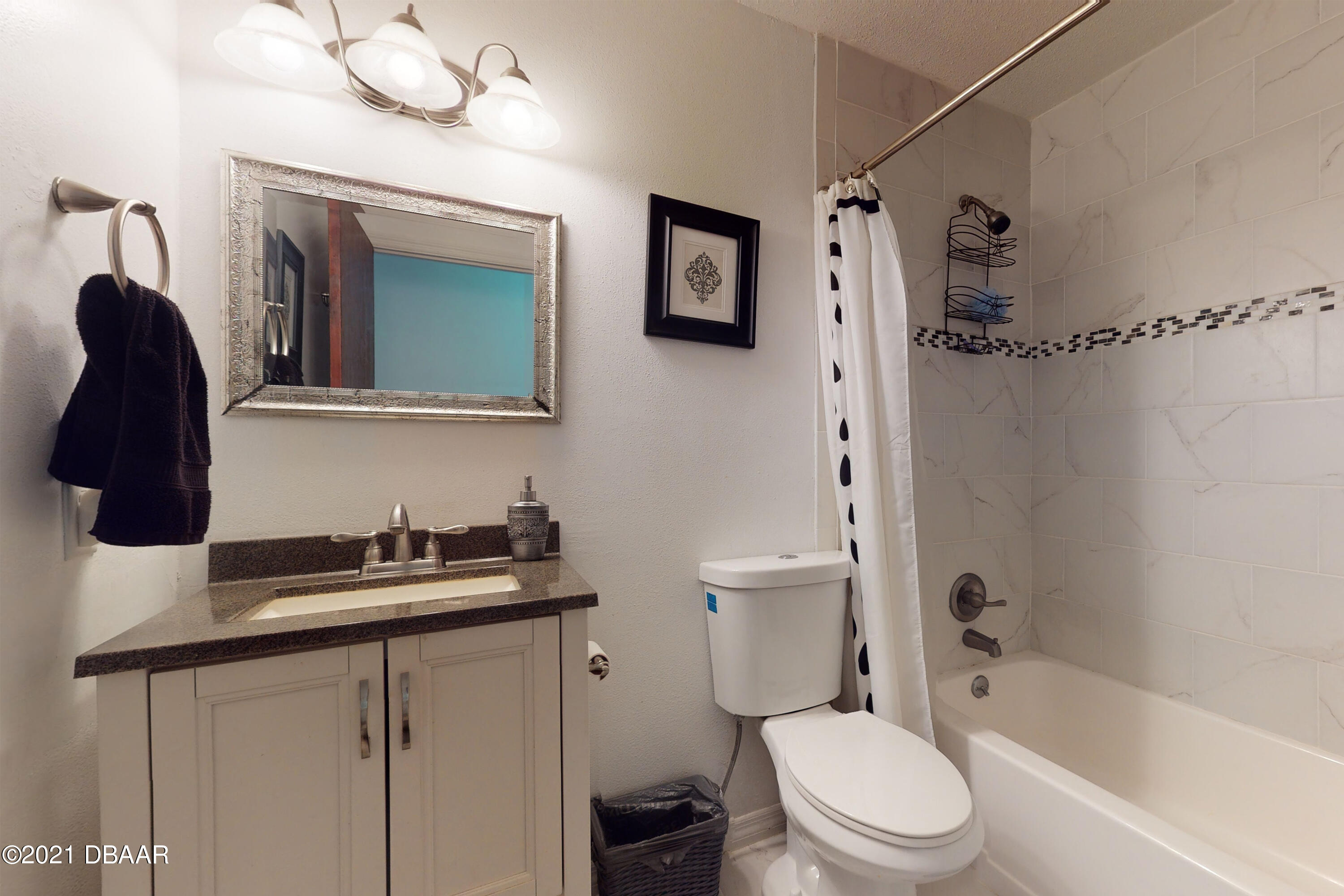 1522 Pine Tree Drive Edgewater, FL 32132 - Photo 10 of 26 a white toilet sitting next to a bathroom sink