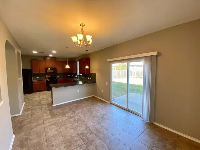 a large kitchen with a refrigerator a sink and a stove