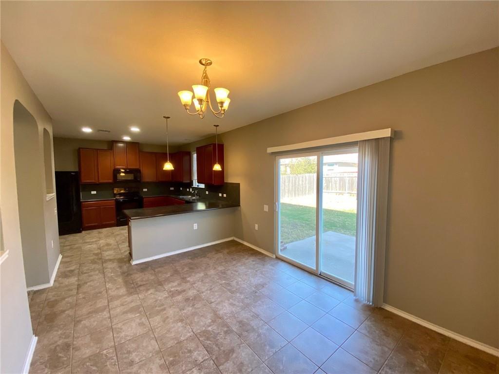 6412 Garden Rose Path Austin, TX 78754 - Photo 2 of 15 a large kitchen with a refrigerator a sink and a stove