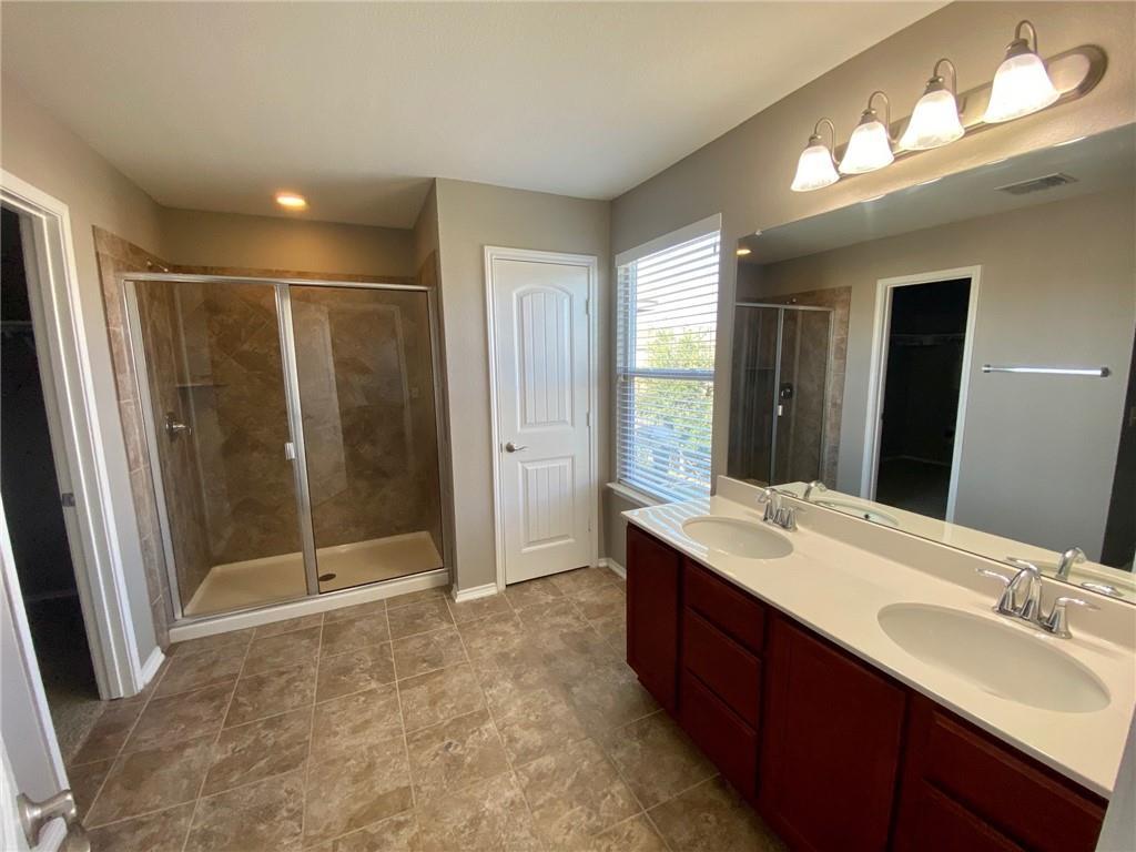 6412 Garden Rose Path Austin, TX 78754 - Photo 8 of 15 a bathroom with a double vanity sink mirror and shower