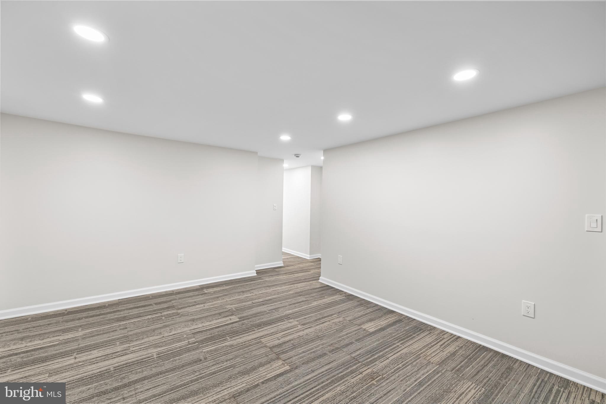 1615 Q Street Northwest, Unit T1 Washington, DC 20009 - Photo 14 of 42 an empty room with wooden floor and white walls