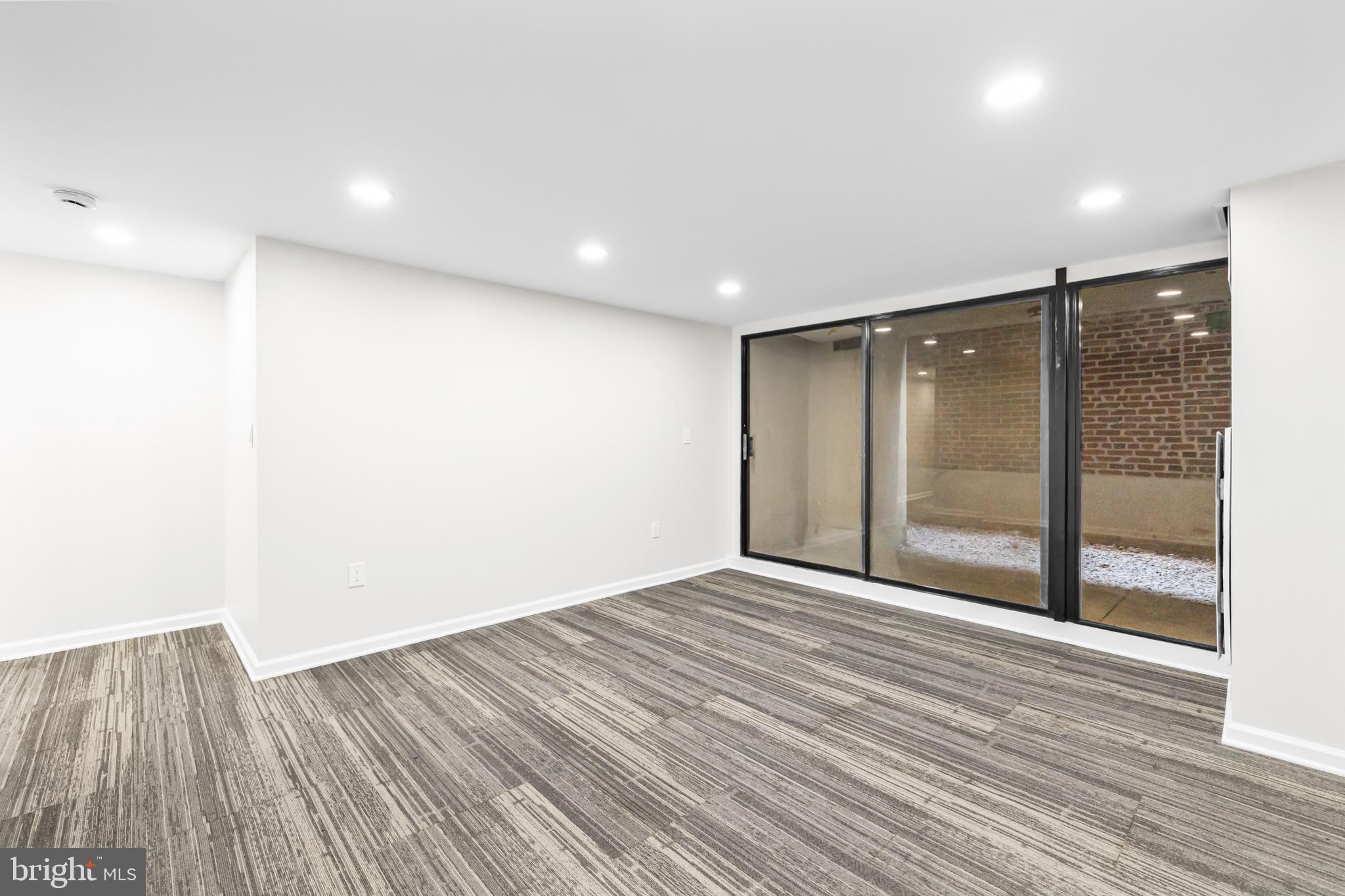 1615 Q Street Northwest, Unit T1 Washington, DC 20009 - Photo 15 of 42 a view of an empty room with wooden floor and a bathroom
