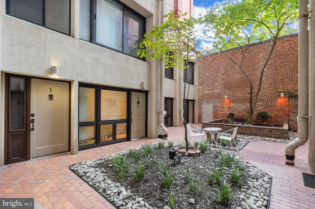 a view of a livingroom with furniture a fireplace a book shelves