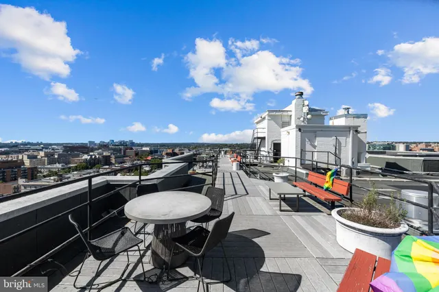 a view of a balcony with table and chairs