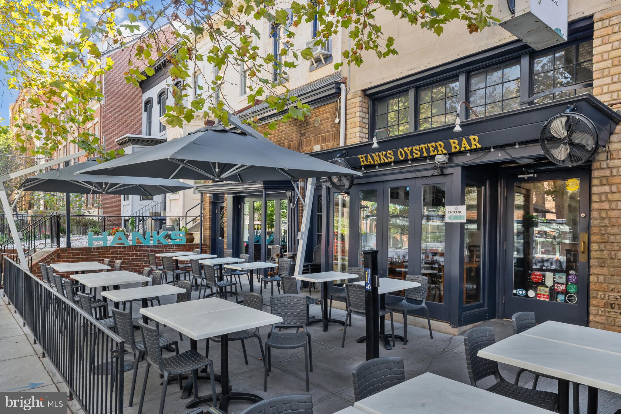 1615 Q Street Northwest, Unit T1 Washington, DC 20009 - Photo 37 of 42 a view of a cafe with a table and chairs under an umbrella