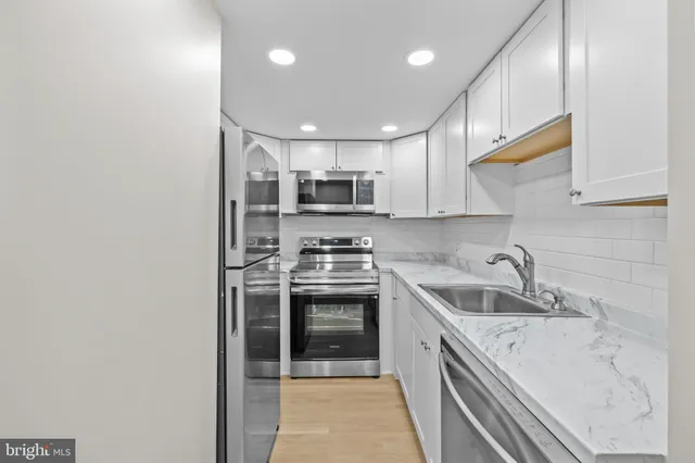 a kitchen with a sink stove and microwave