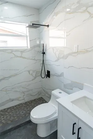 a bathroom with a toilet and a shower