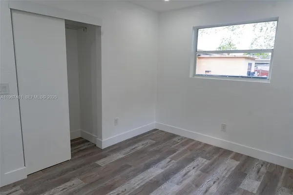 a view of hallway with wooden floor