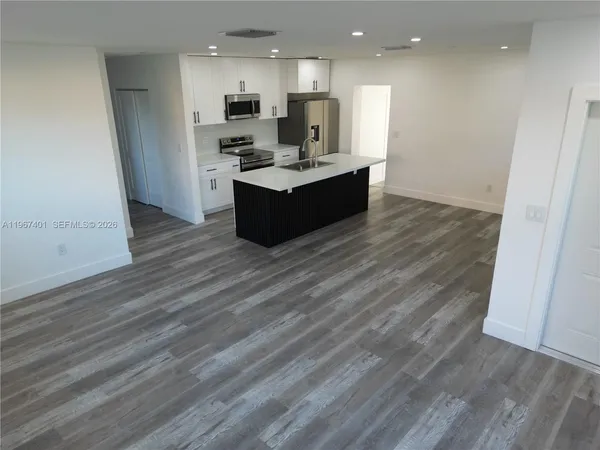 a view of kitchen view wooden floor and electronic appliances