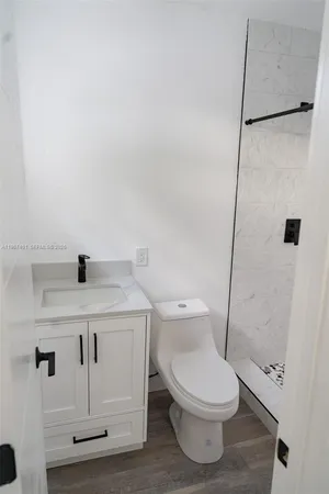 a white toilet sitting next to a bathroom sink
