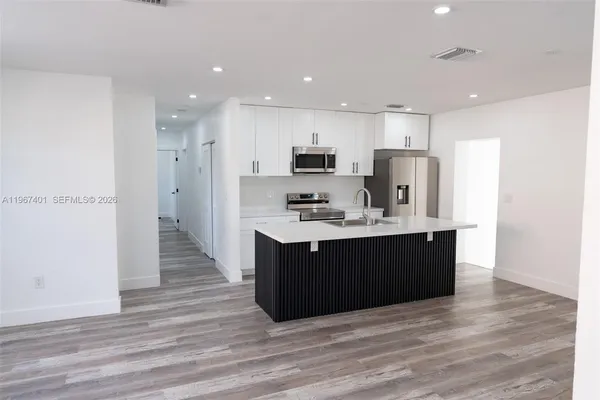 a kitchen with wooden cabinets and sink