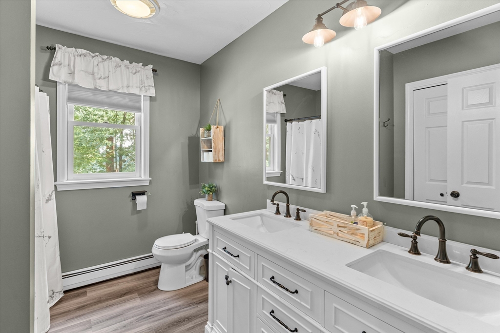 12 Easter Brook Road Lunenburg, MA 01462 - Photo 16 of 41 a bathroom with a double vanity sink toilet and a mirror