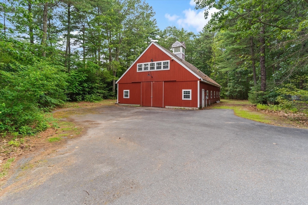 12 Easter Brook Road Lunenburg, MA 01462 - Photo 33 of 41 a view of barn with a big yard and large trees