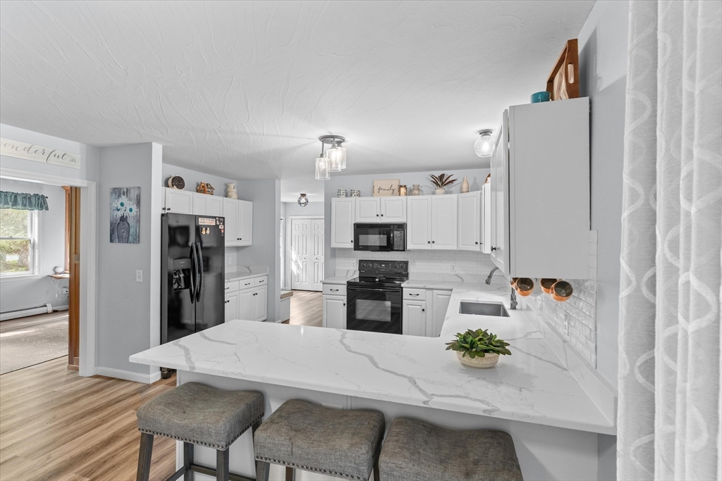 12 Easter Brook Road Lunenburg, MA 01462 - Photo 4 of 41 a kitchen with stainless steel appliances kitchen island granite countertop a refrigerator and a stove top oven