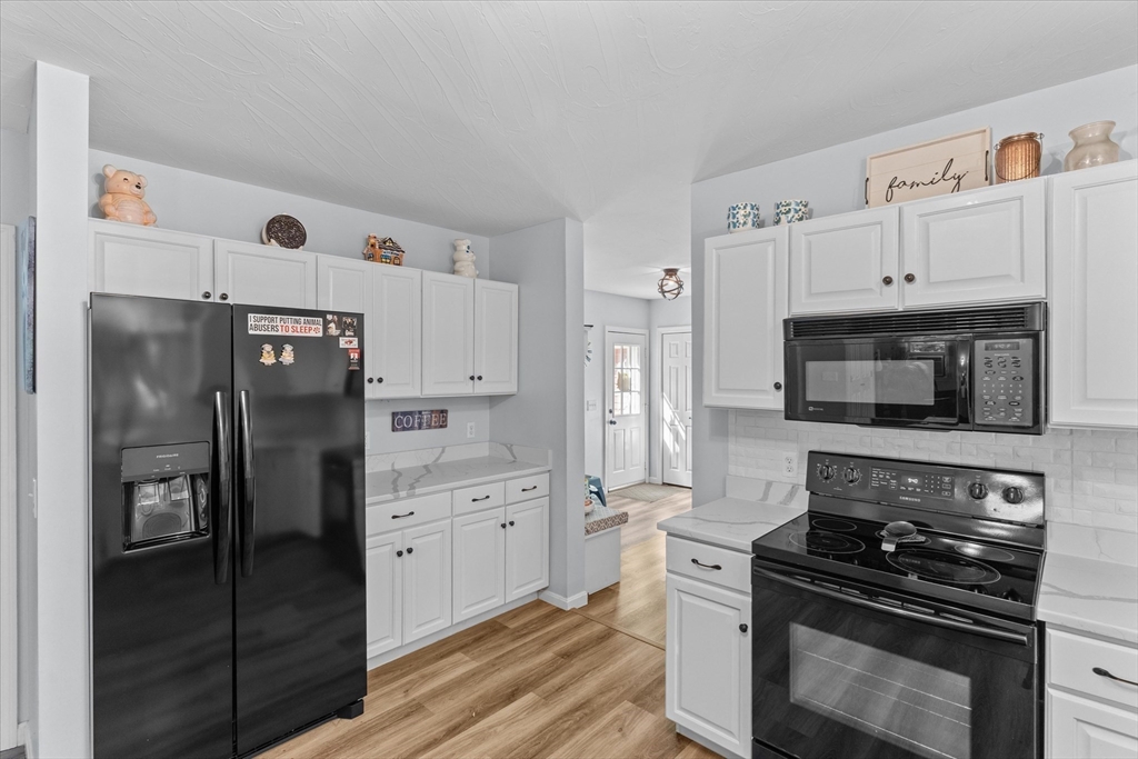 12 Easter Brook Road Lunenburg, MA 01462 - Photo 5 of 41 a kitchen with stainless steel appliances and white cabinets