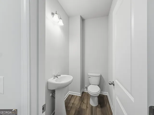 a bathroom with a toilet sink and a mirror