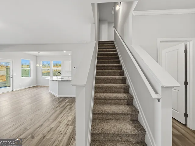 a view of an entryway with wooden floor and stairs