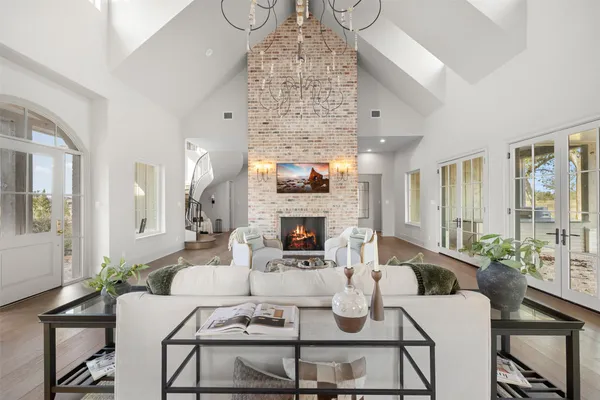 a living room with furniture large window and a fireplace