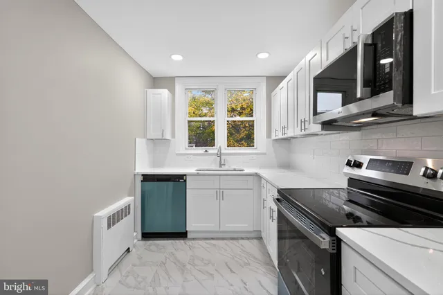 a kitchen with a sink stove top oven and cabinets