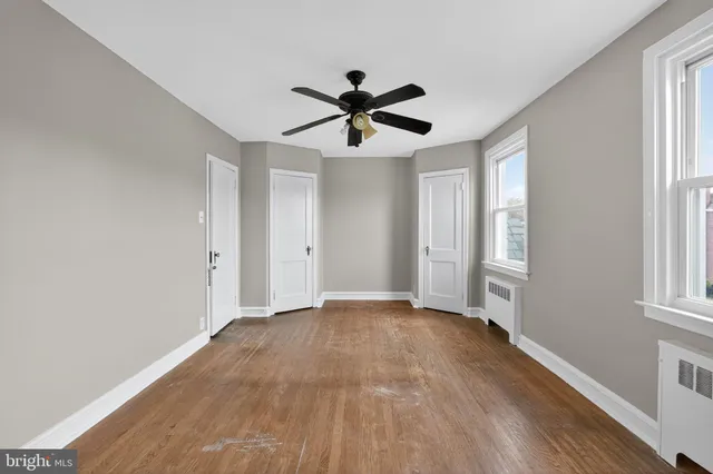 a view of a livingroom with a window and a ceiling fan