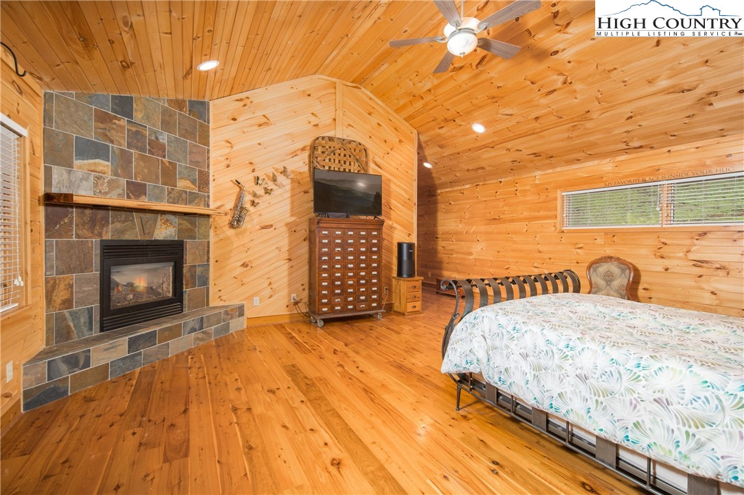 175 Woods Road Boone, NC 28607 - Photo 20 of 50 a bedroom with a bed and a fireplace
