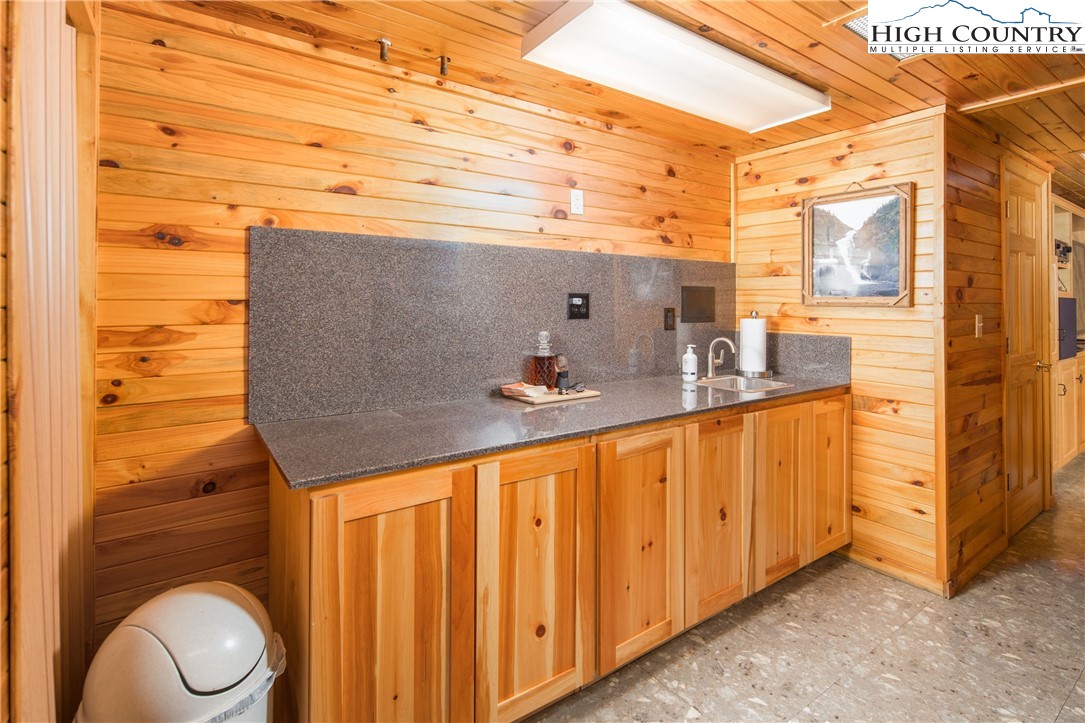 175 Woods Road Boone, NC 28607 - Photo 40 of 50 a bathroom with a granite countertop sink and a mirror