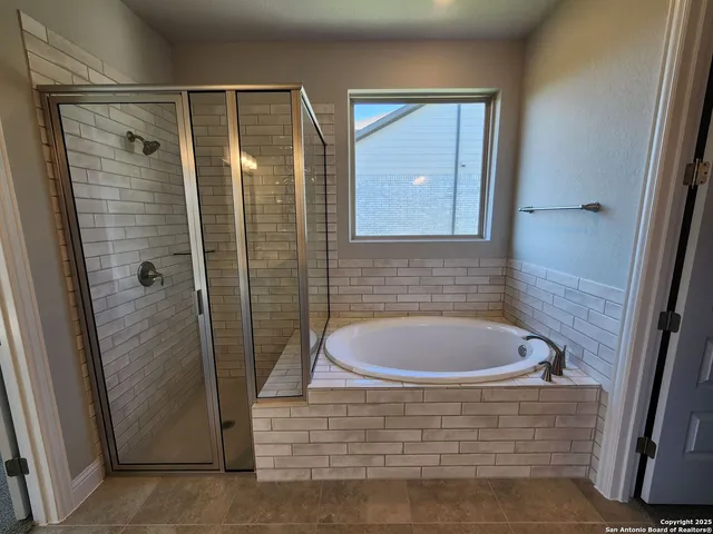 a bathroom with a bathtub and shower