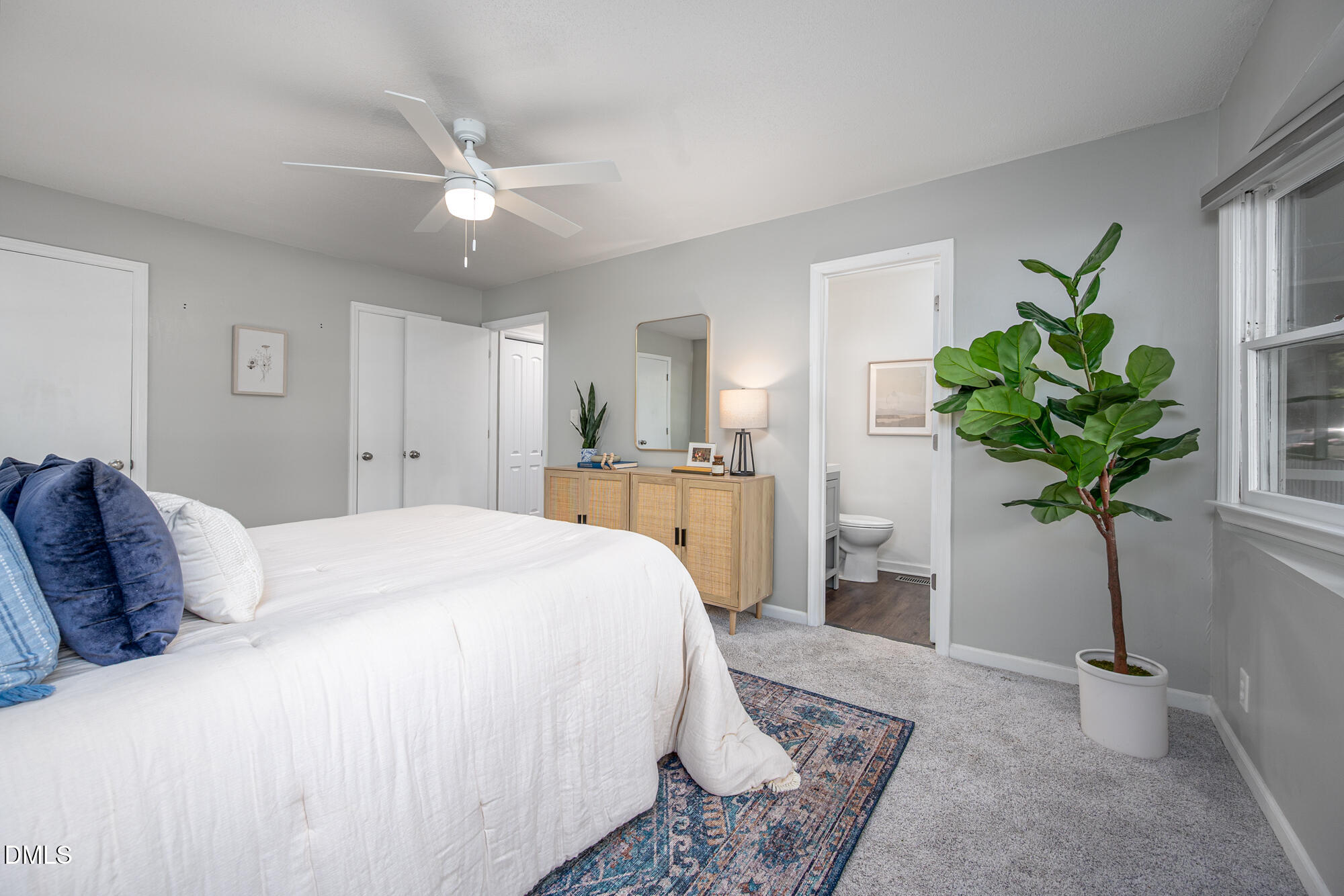 132 Hudson Hills Road Pittsboro, NC 27312 - Photo 16 of 43 a spacious bedroom with a bed and a potted plant