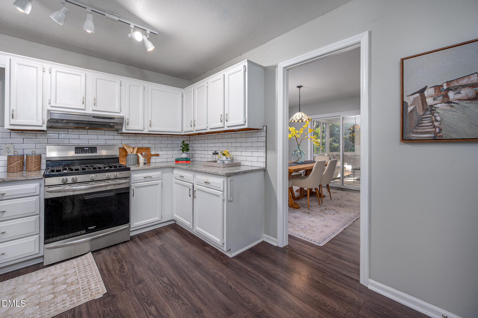 132 Hudson Hills Road Pittsboro, NC 27312 - Photo 8 of 43 a kitchen with stainless steel appliances granite countertop a stove top oven a sink dishwasher and a refrigerator with wooden floor