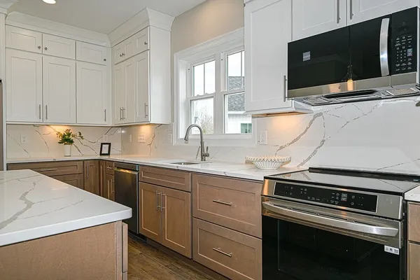 a kitchen with a sink stove and microwave