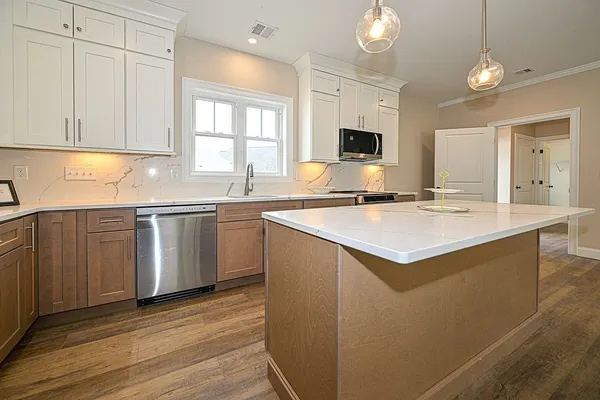 a kitchen with a sink and cabinets