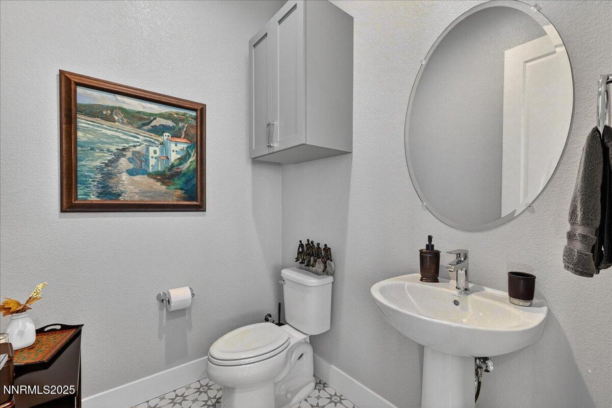 2160 Woodhouse Drive Reno, NV 89521 - Photo 12 of 38 a bathroom with a toilet a sink and a mirror