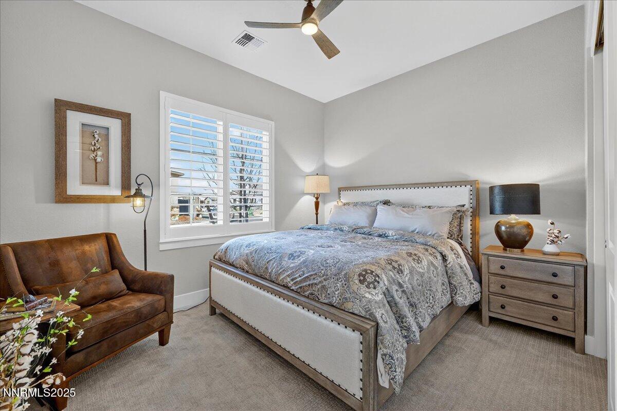 2160 Woodhouse Drive Reno, NV 89521 - Photo 19 of 38 a spacious bedroom with a bed and a couch