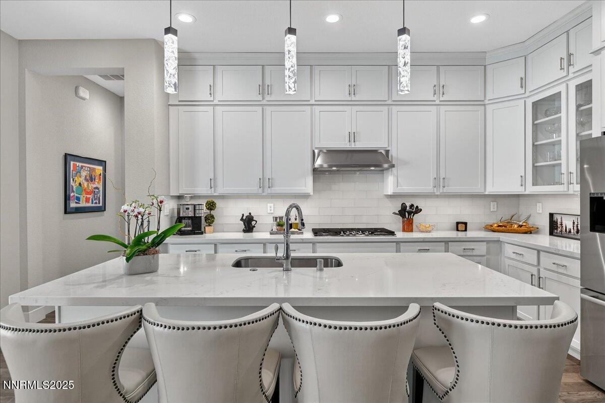 2160 Woodhouse Drive Reno, NV 89521 - Photo 8 of 38 a kitchen with stainless steel appliances a white table chairs and a refrigerator