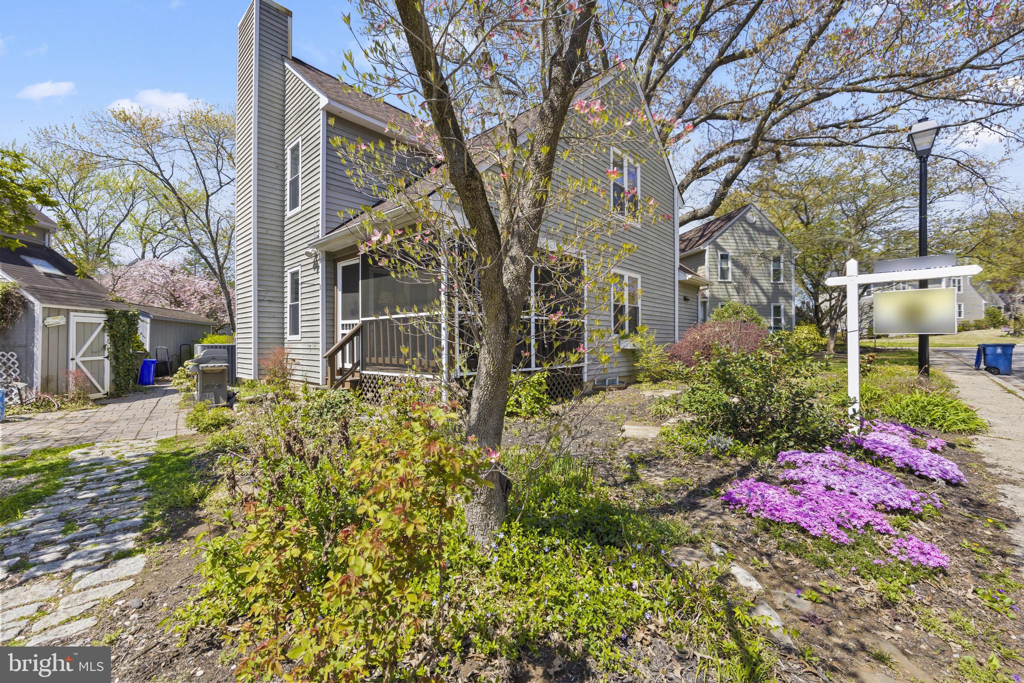 Charming home with vibrant gardens.