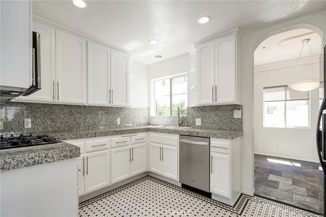 a kitchen with a sink stove and cabinets