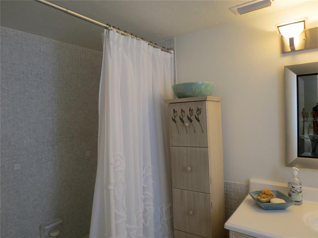615 South Palm Avenue, Unit 4 Sarasota, FL 34236 - Photo 13 of 16 a bathroom with a sink and a shower curtain